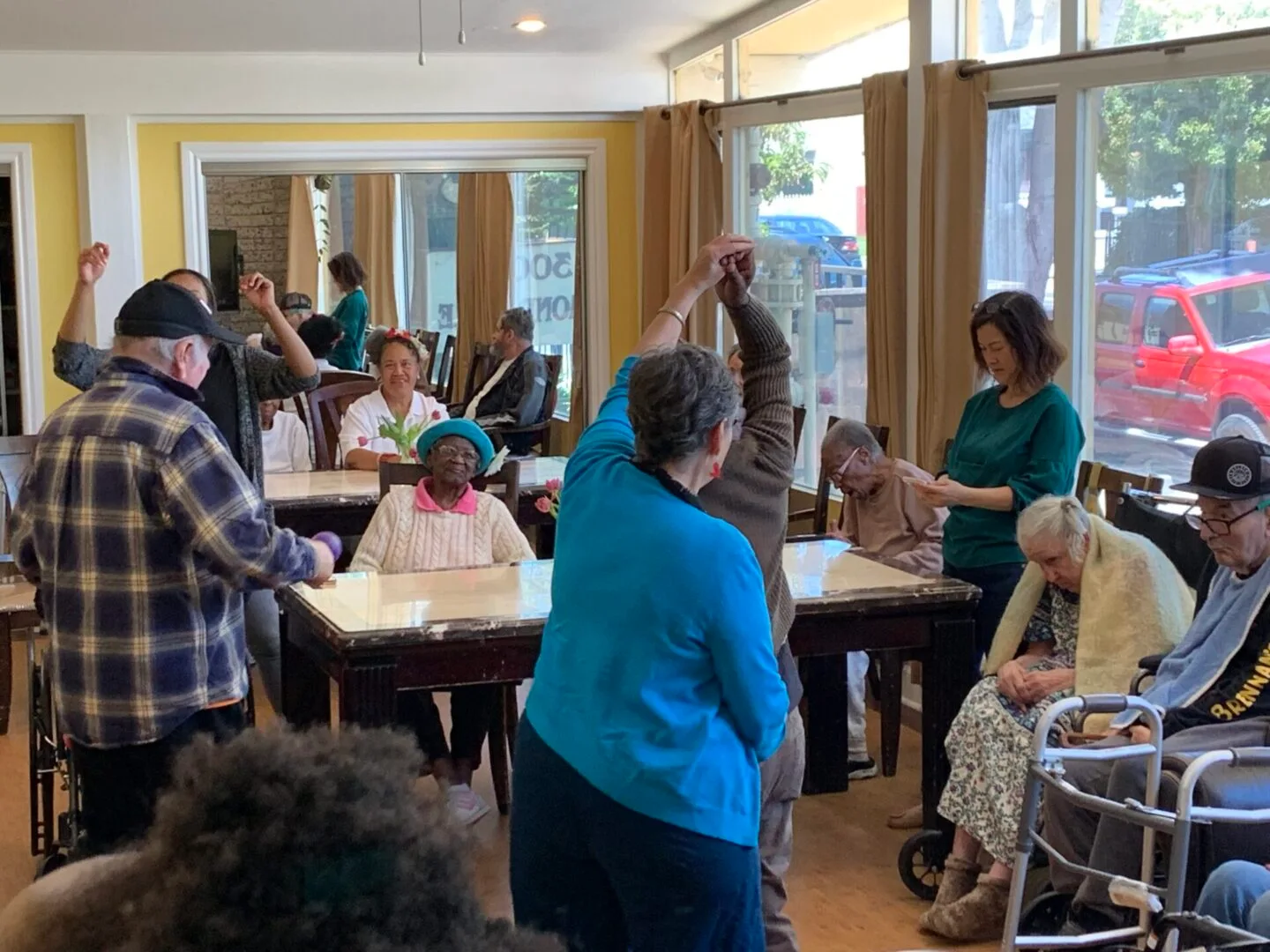 Residents and visitors spending time together in Dimond Care’s sunny shared living area